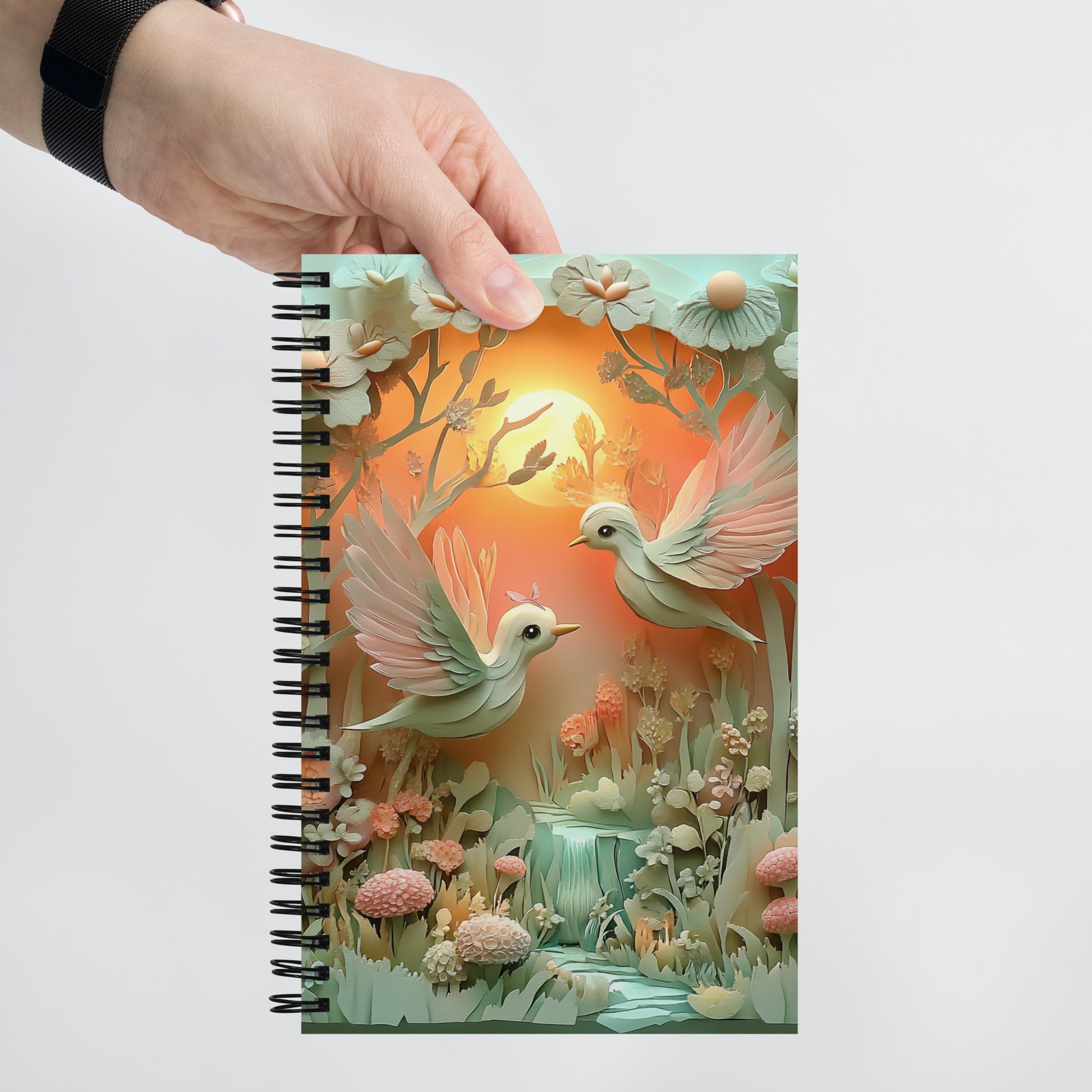 Handheld view of a notebook of two love birds.