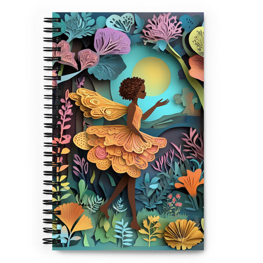 A spiral notebook with a fairy in a garden.