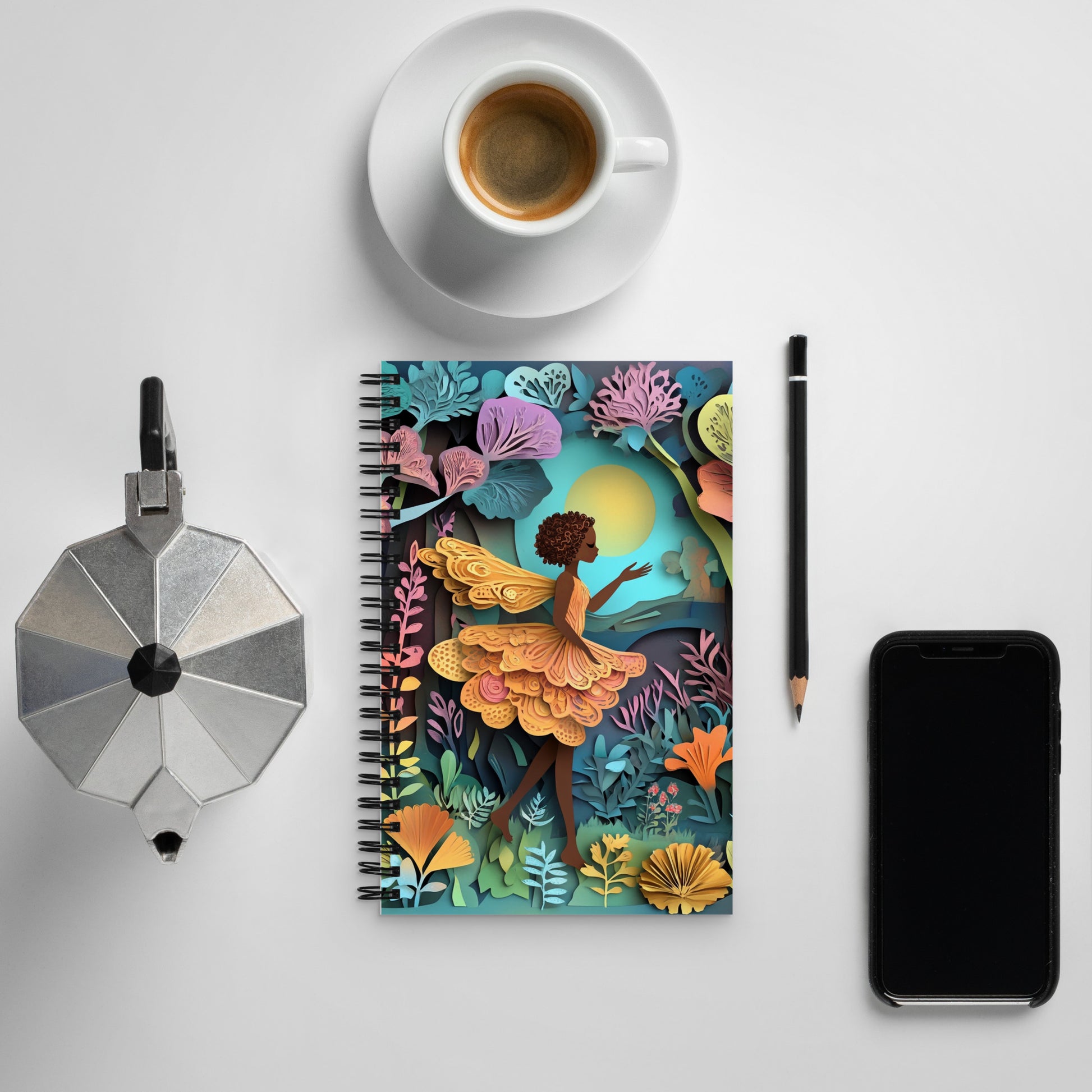 Top front view of a notebook with a fairy in a garden.