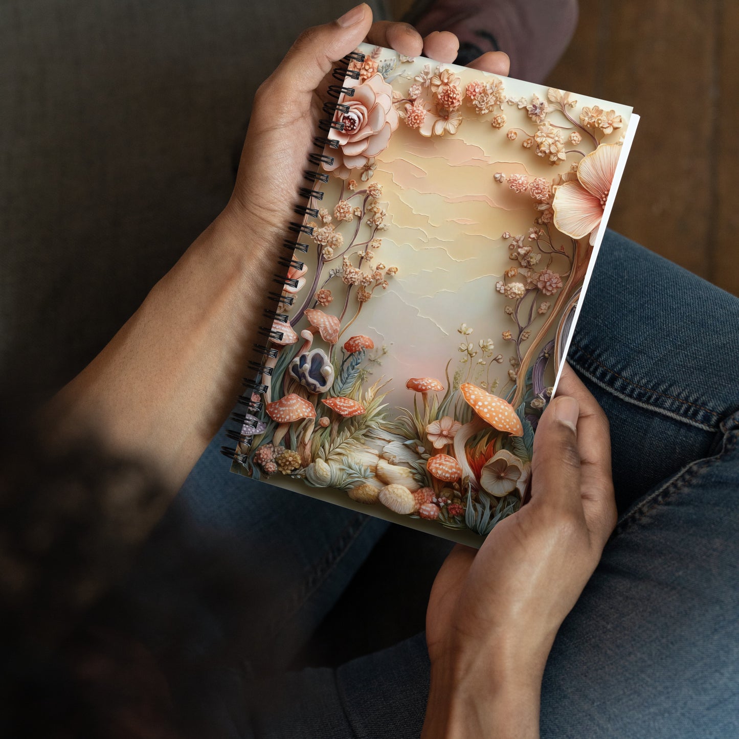 Handheld perspective view of a notebook with a magical mushroom border.